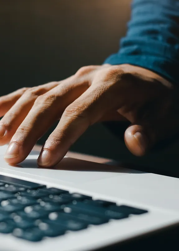 hand on a laptop keyboard typing