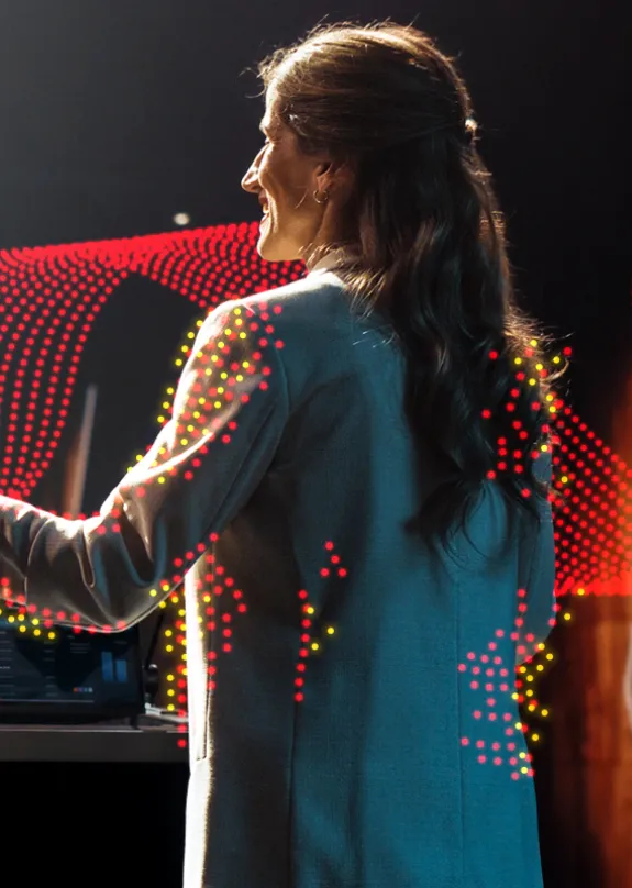 Woman making a speech to a large theatre audience