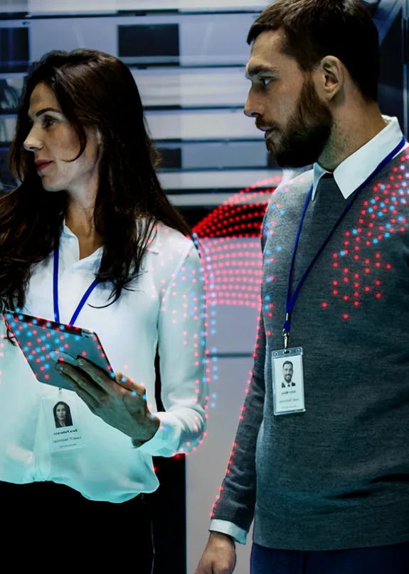 Man and Woman stood looking at a server